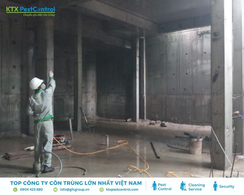 Kỹ thuật viên đang phun thuốc diệt mối trong khu vực xây dựng ở huyện Quốc Oai